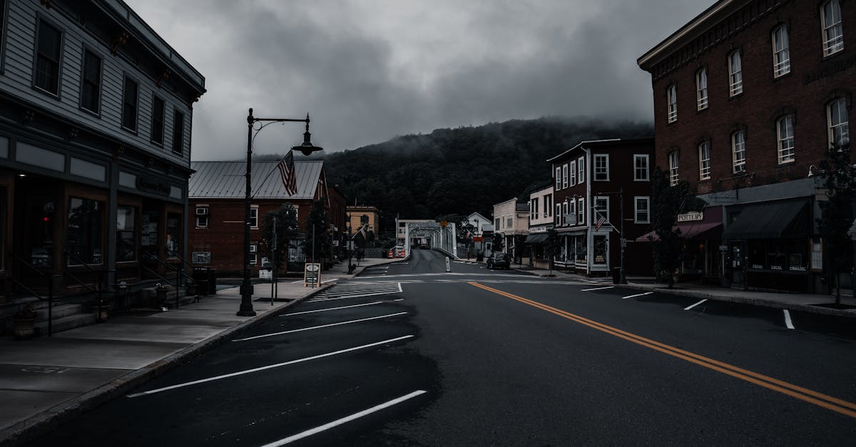 Empty town street with historic buildings and moody clouds. Perfect for travel or urban exploration themes.